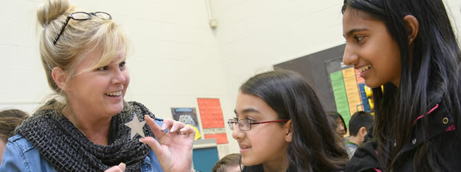 Woman and two female students