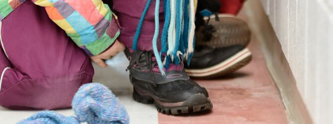 Student putting on a winter boot